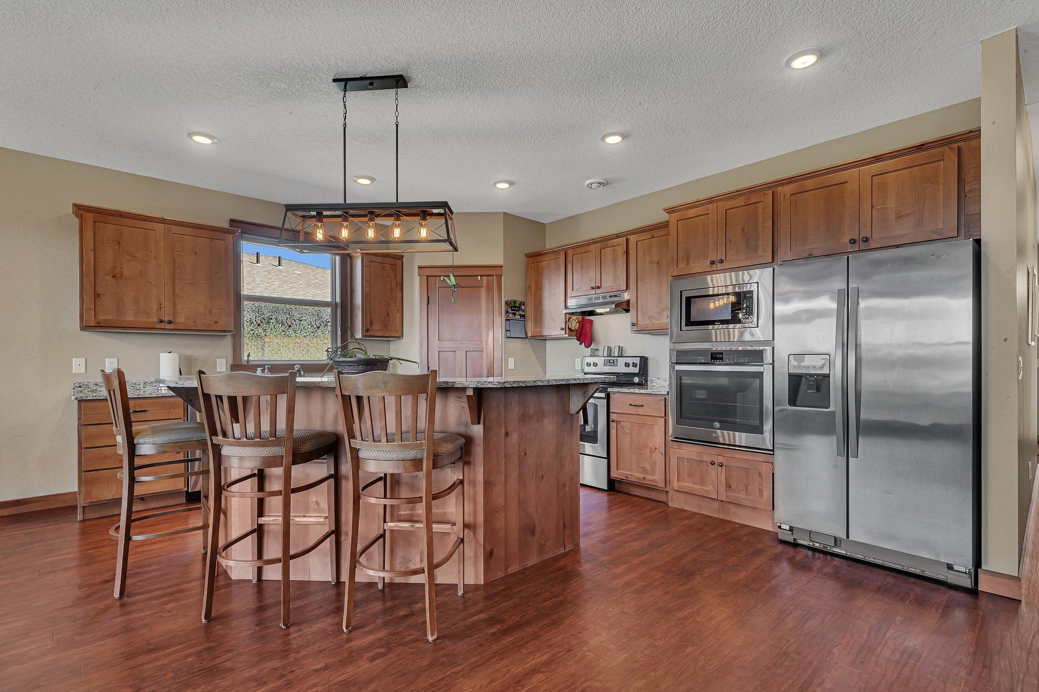 Stainless steel appliances throughout the kitchen, with wall oven in addition to the range.