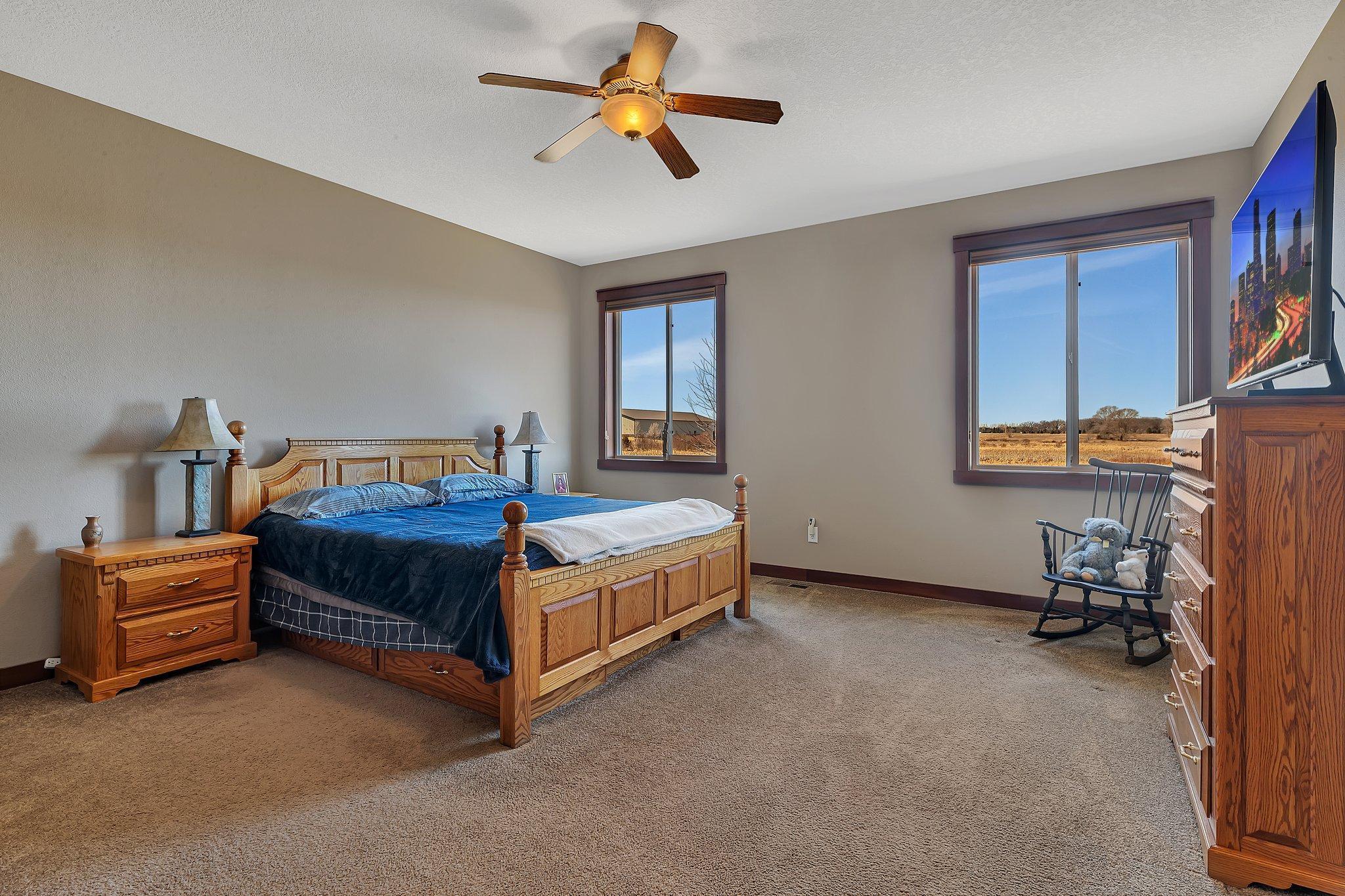 Primary bedroom with space for multiple furniture pieces.