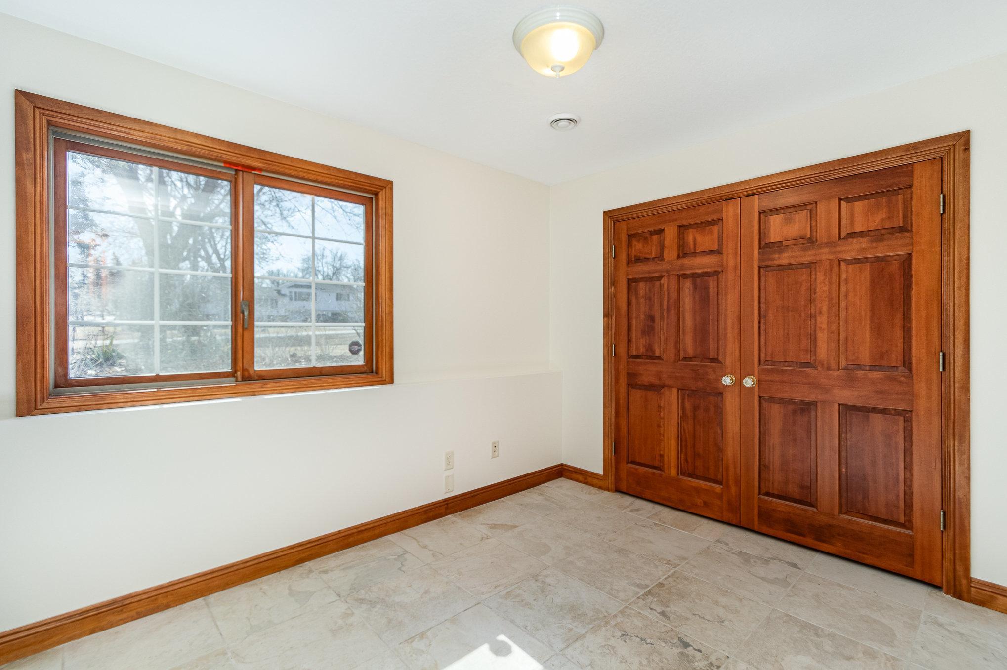 Located just down the hall from the master suite, the large second bedroom offers plenty of space and comfort. A generous closet provides ample storage, while its convenient location ensures easy access to the lower-level bathroom.