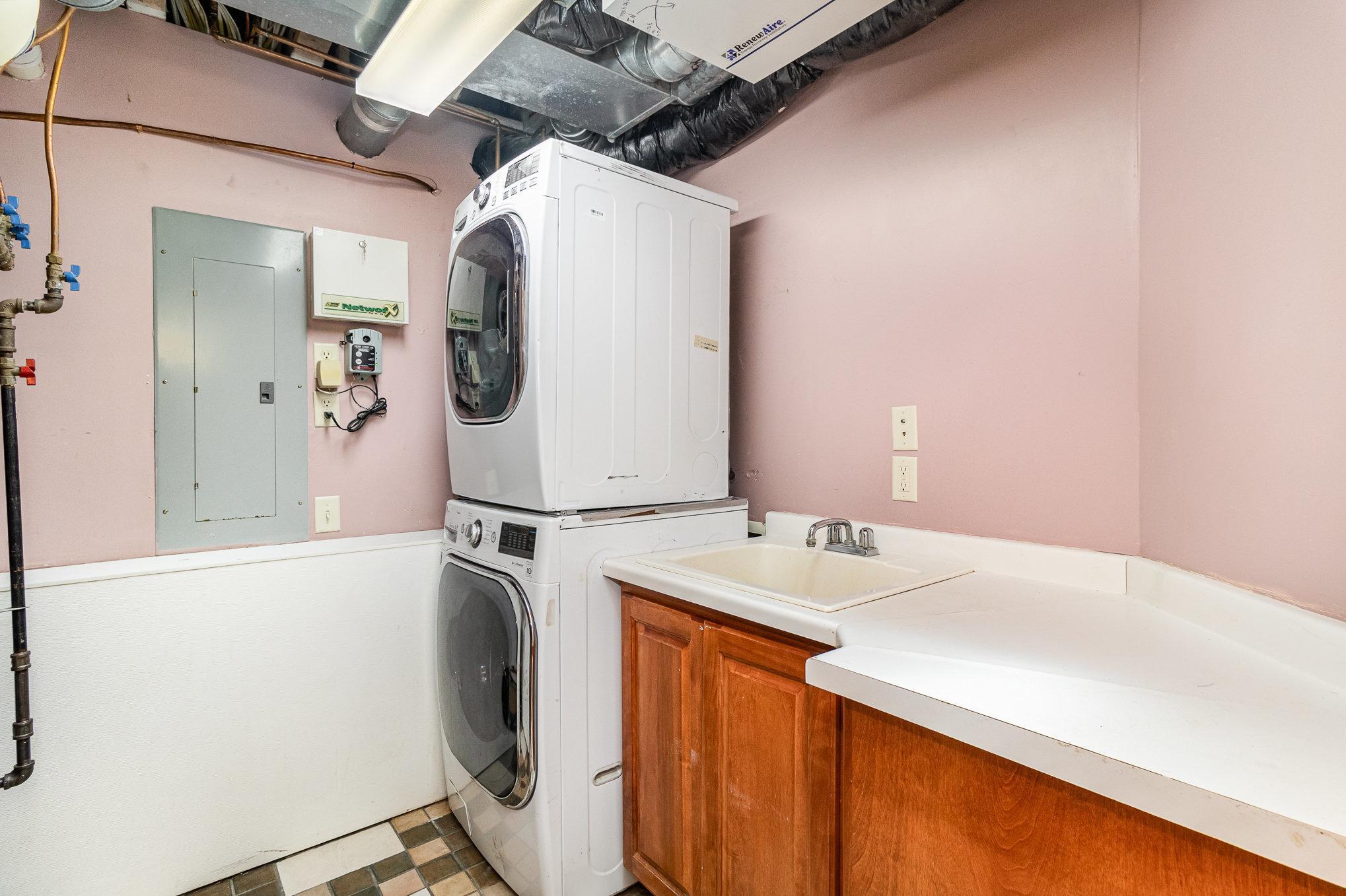 The lower-level laundry room offers ample space for all your washing and drying needs, making household chores a breeze. This room also houses the home's high-efficiency furnace, water softener, whole-house filter, and on-demand hot water system.