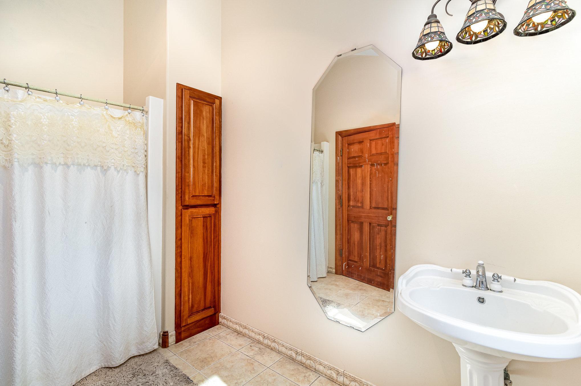 The main level bathroom also features a full tub and shower as well as a large window creating a bright and refreshing atmosphere.