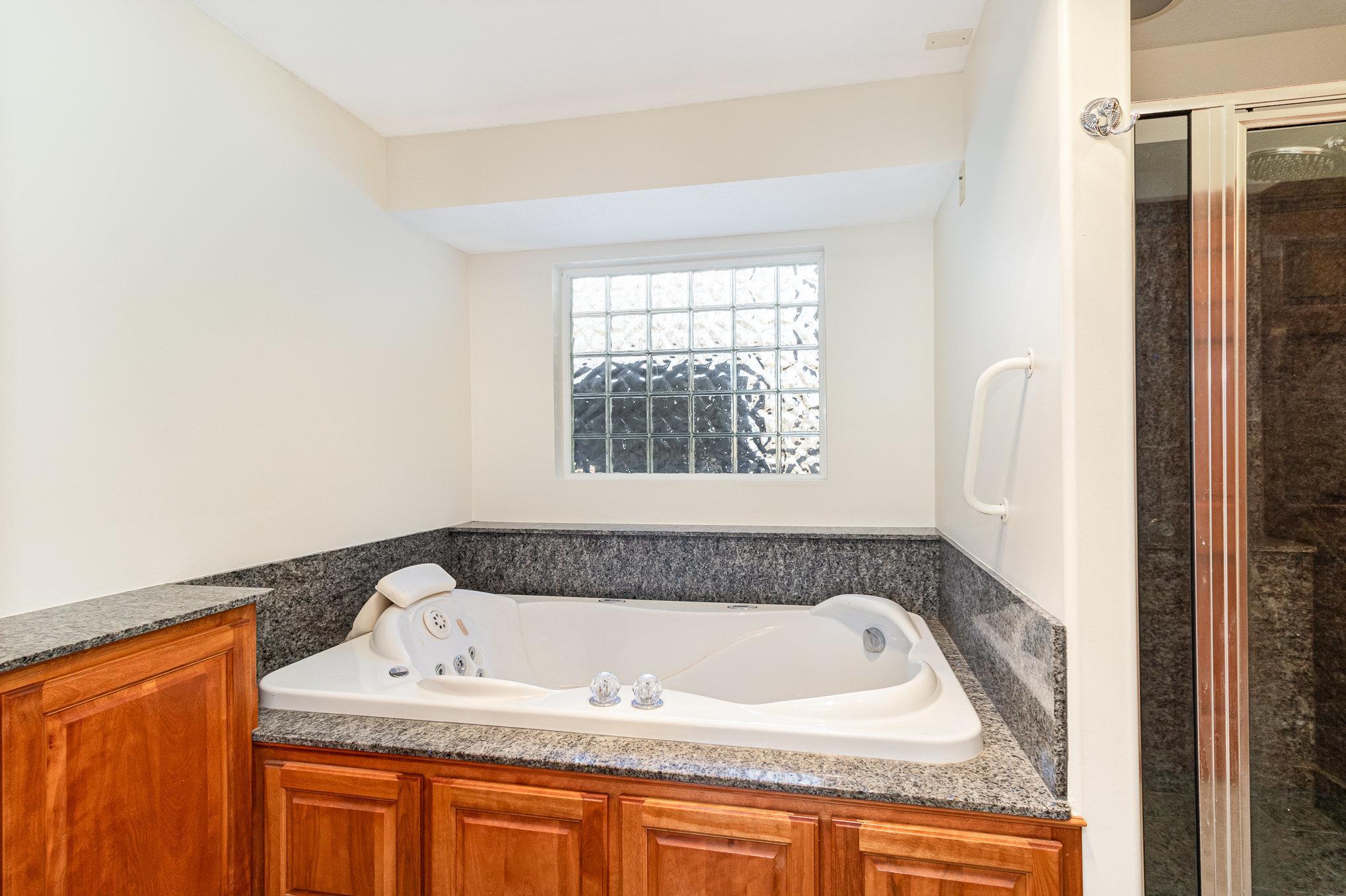 Large jetted tub located in the master bath is a great place to relax and replenish.