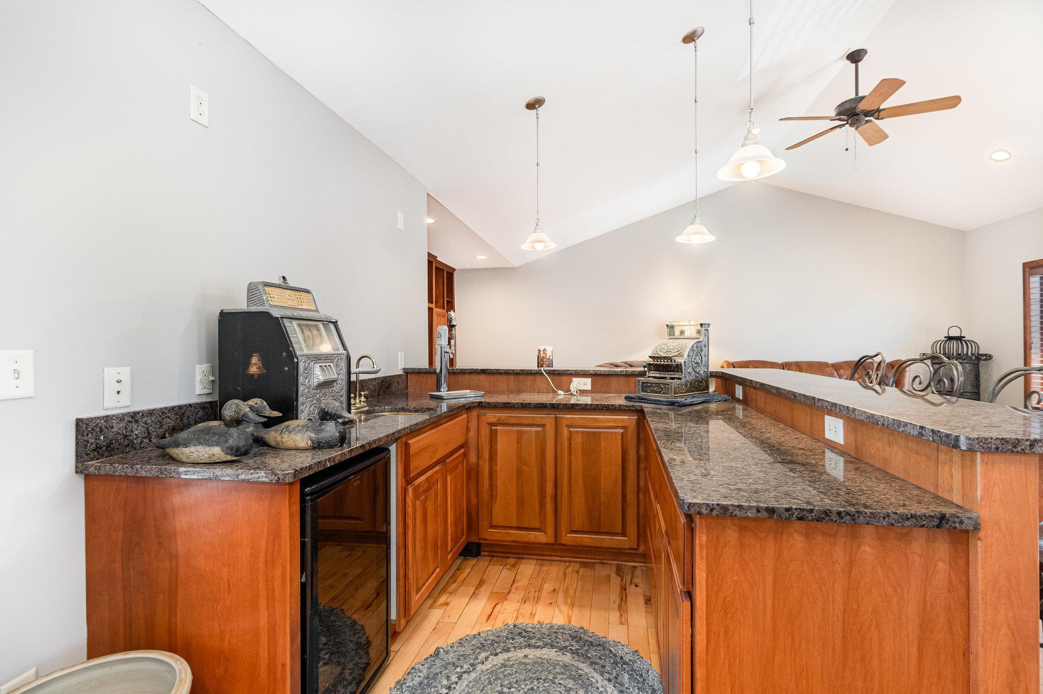 You will love this part of the home because it features a wet bar, under counter refrigerator and kegerator, making it the perfect gathering spot for friends and family