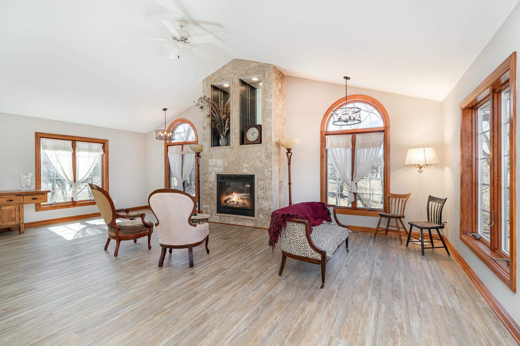 The heart of the living space is a grand, fully functional marble fireplace, adding both warmth and sophistication to the home. Whether you're enjoying a quiet evening or hosting guests this fireplace is a true standout feature.