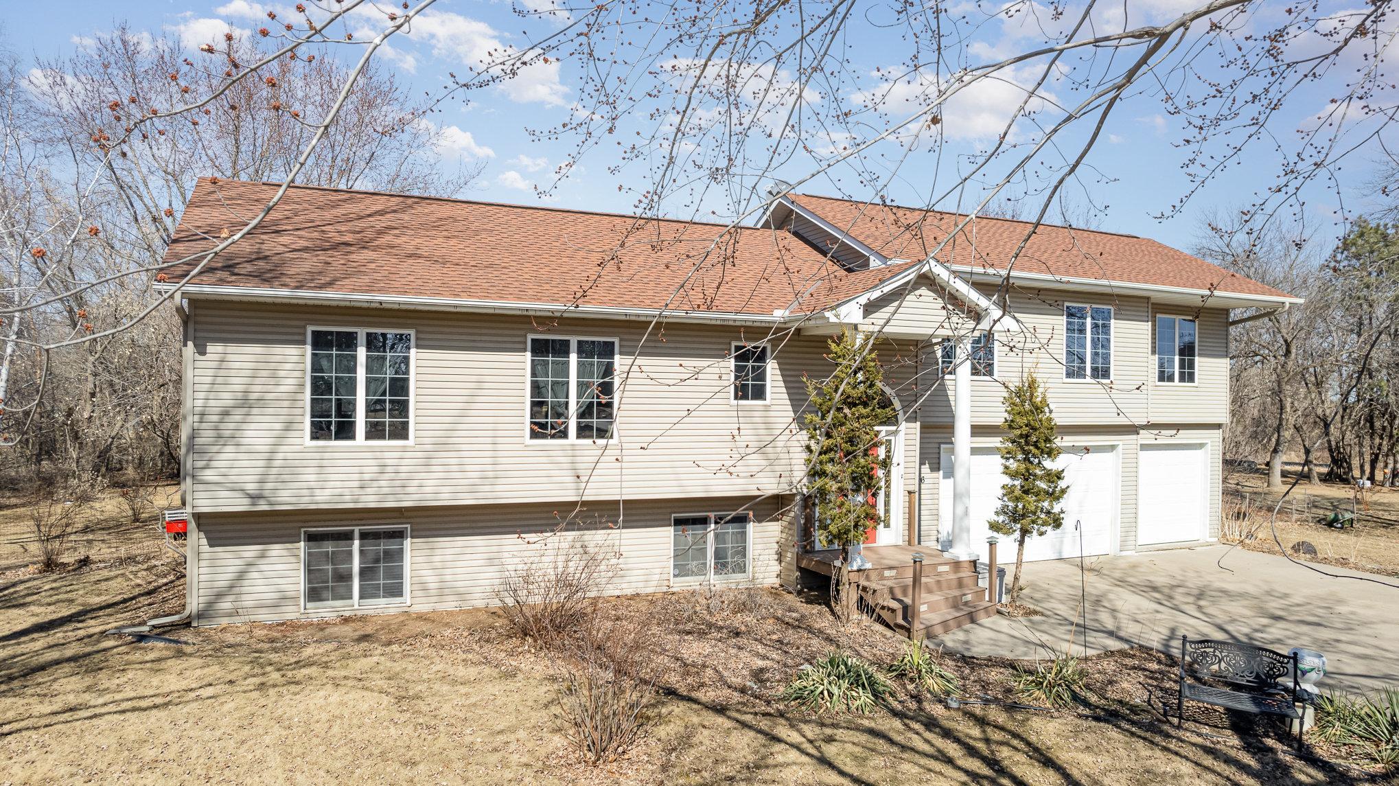 This home is bathed in natural light, thanks to the numerous oversized windows placed throughout. These expansive windows not only brighten each room but also offer stunning views of the surrounding 1.2-acre property.