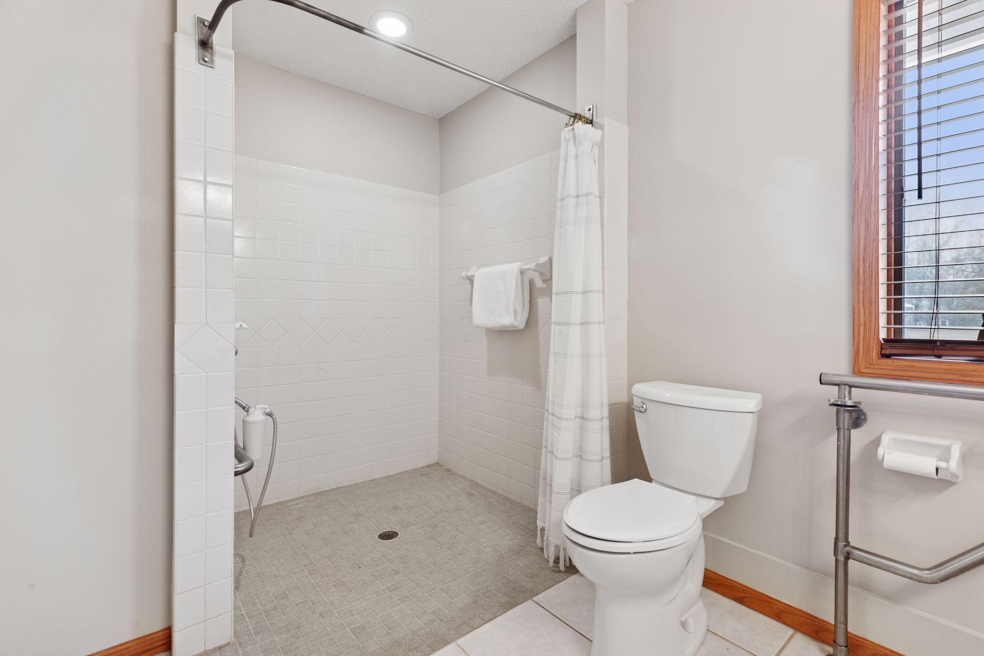 The highlight of the space is the huge walk-in/roll-in shower, offering ultimate comfort and convenience without compromising on style—perfect for a relaxing, spa-like experience every day.