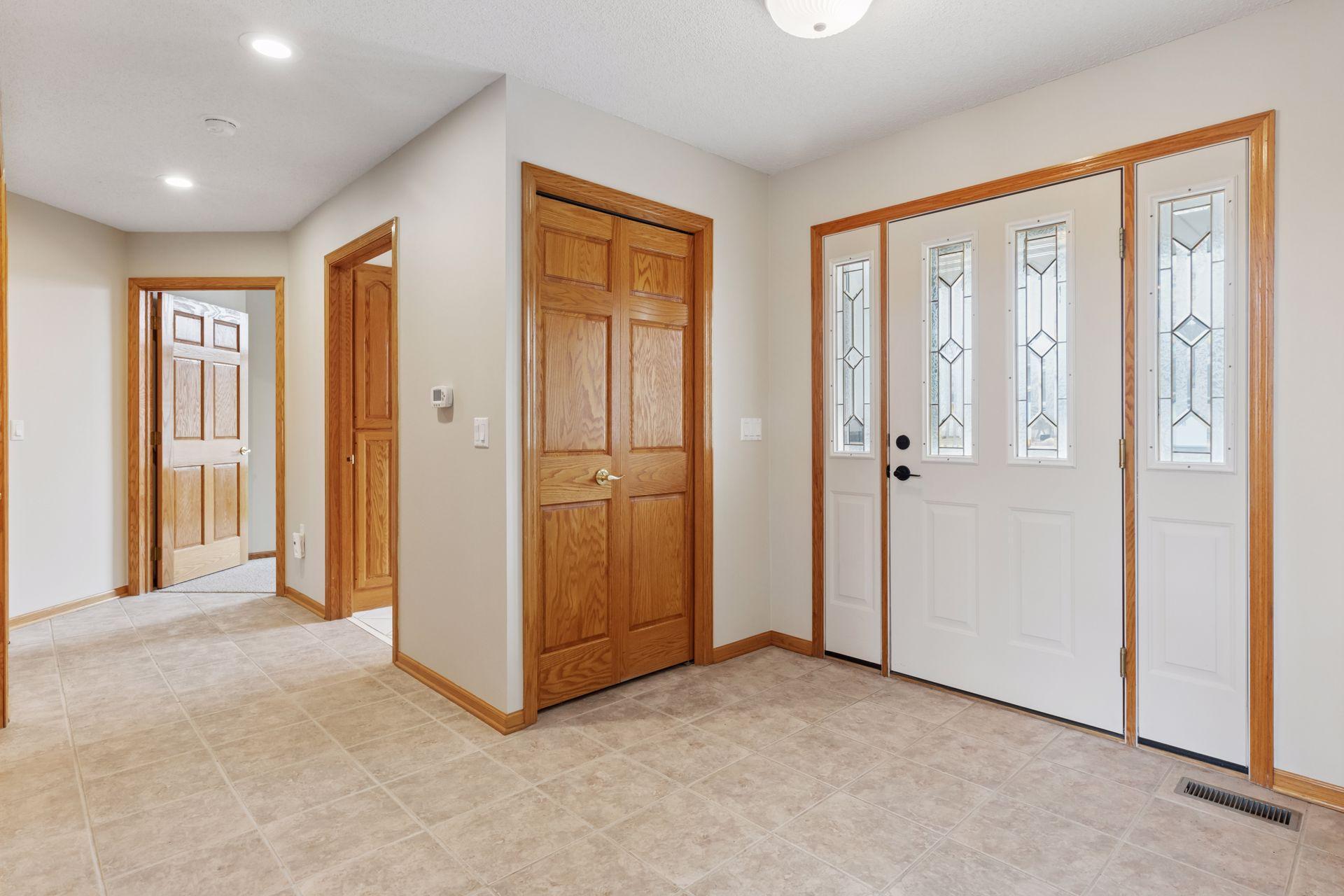 The spacious entry offers not only a grand first impression but also functionality with two convenient coat closets, perfect for keeping your space organized and clutter-free. The inviting front door, flanked by two elegant sidelight windows.