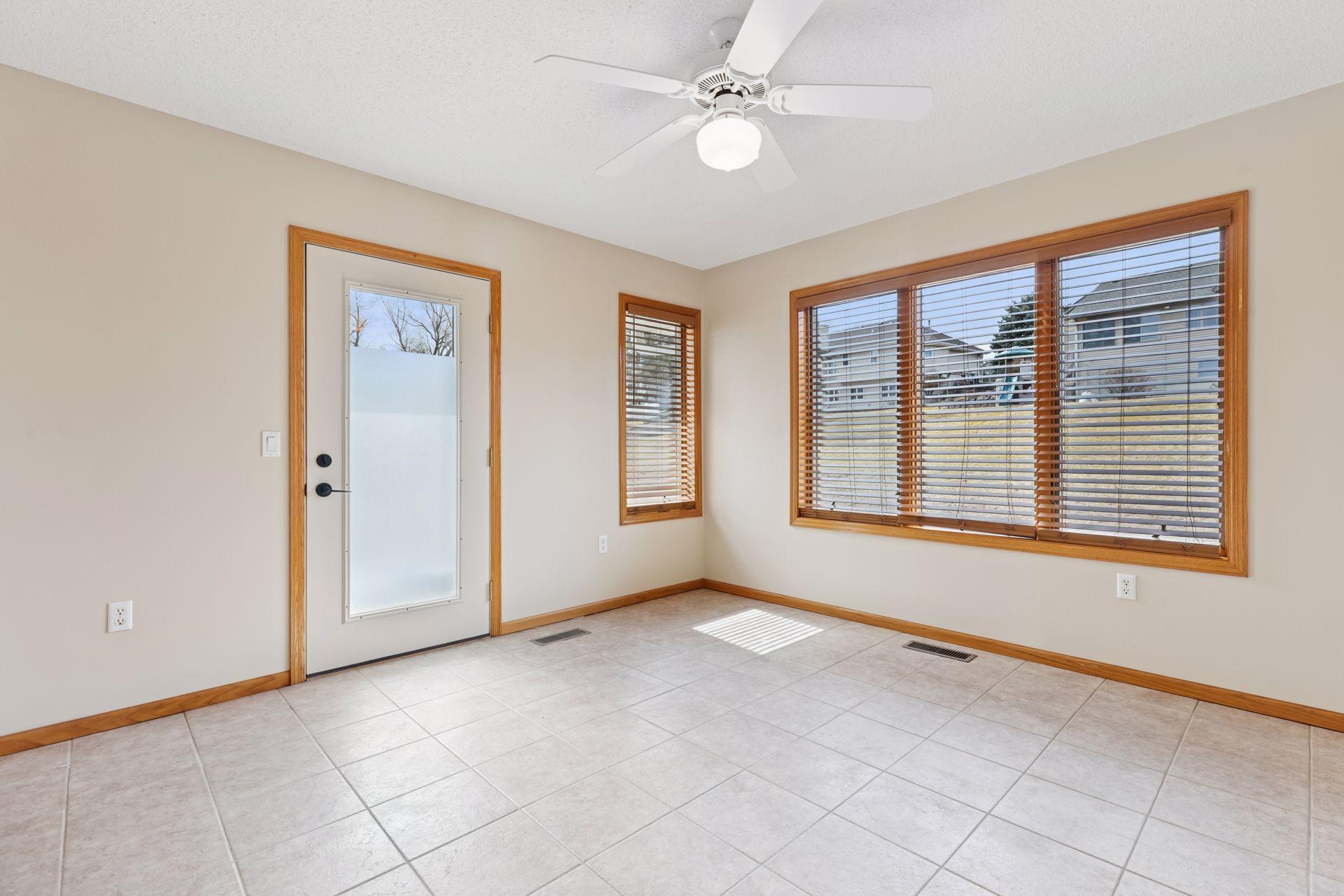 Sunroom/flex space is located off the owner's bedroom, plenty or natural light and access door to backyard.