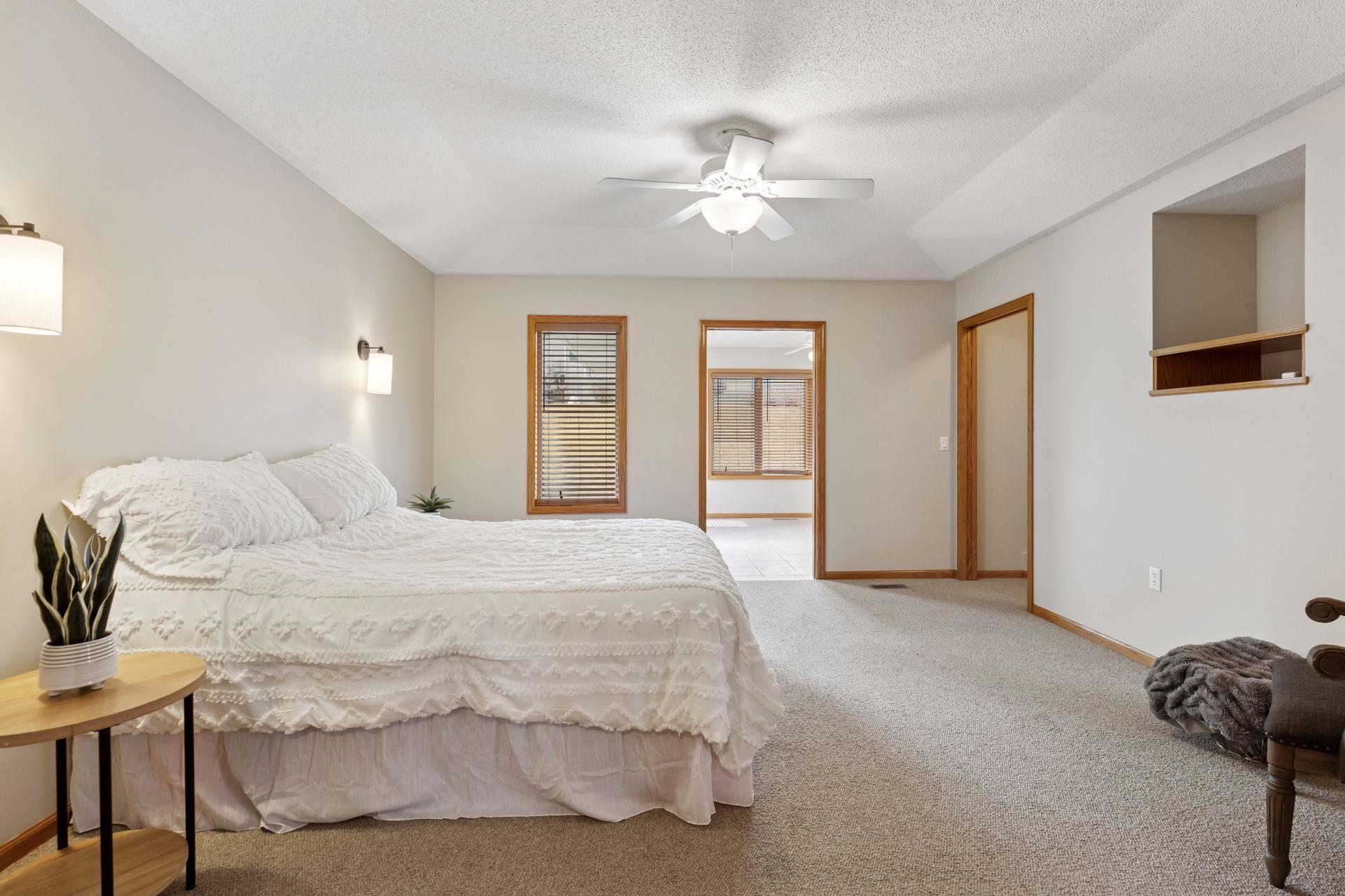 This generously sized sanctuary features a ceiling fan to keep you cool and comfortable year-round, while elegant wall sconces add a touch of sophistication and create a warm, inviting ambiance.