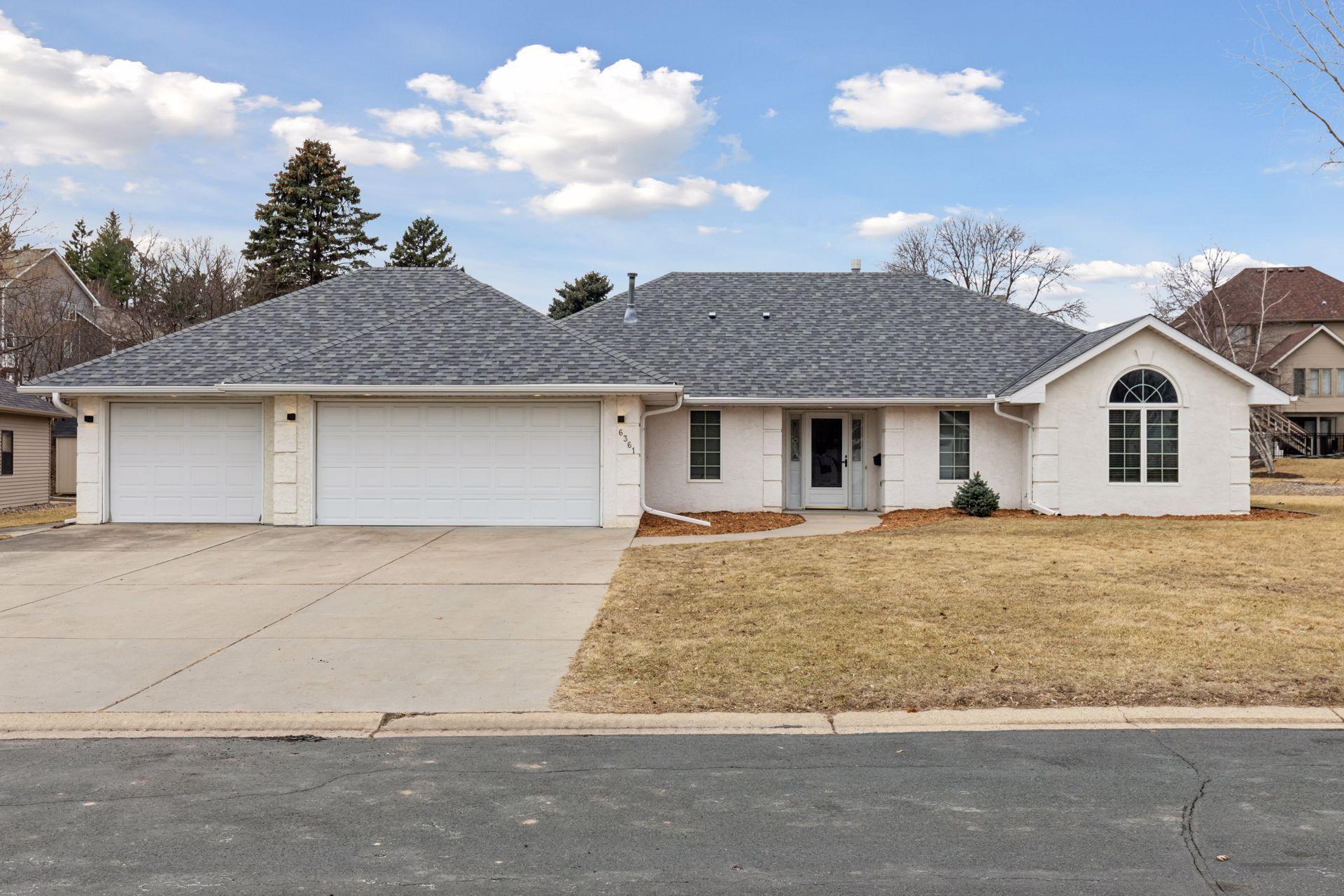 Welcome to your dream home! This stunning property boasts an attractive white stucco exterior. The freshly updated mulch landscaping enhances the home's curb appeal, creating a warm and inviting atmosphere.