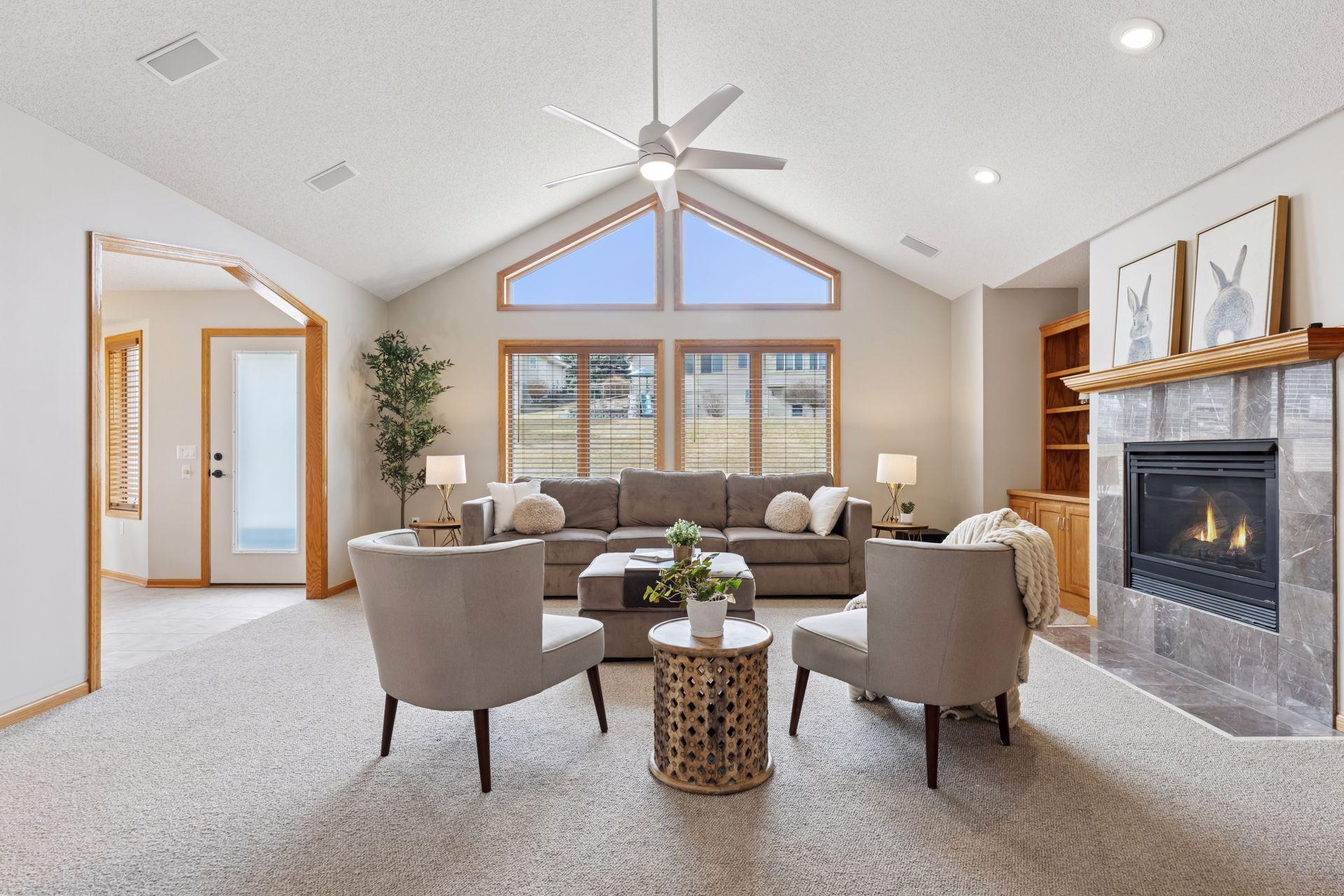 The living room is a true showstopper, featuring soaring vaulted ceilings and clerestory windows that flood the space with natural light, creating an open and airy ambiance.