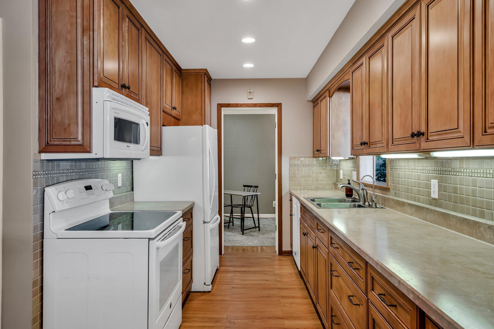 Tons of counter and cabinet space. Kitchen has an opening into the 4 season porch!