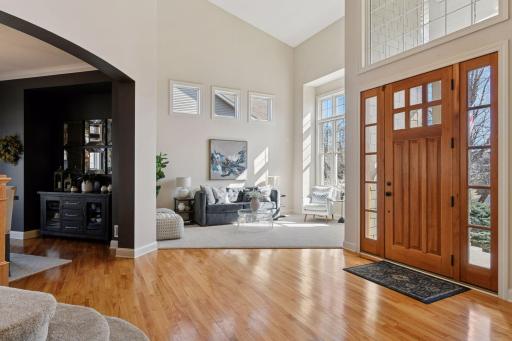 Foyer opens to formal living room. Tons of natural light flood the entryway.
