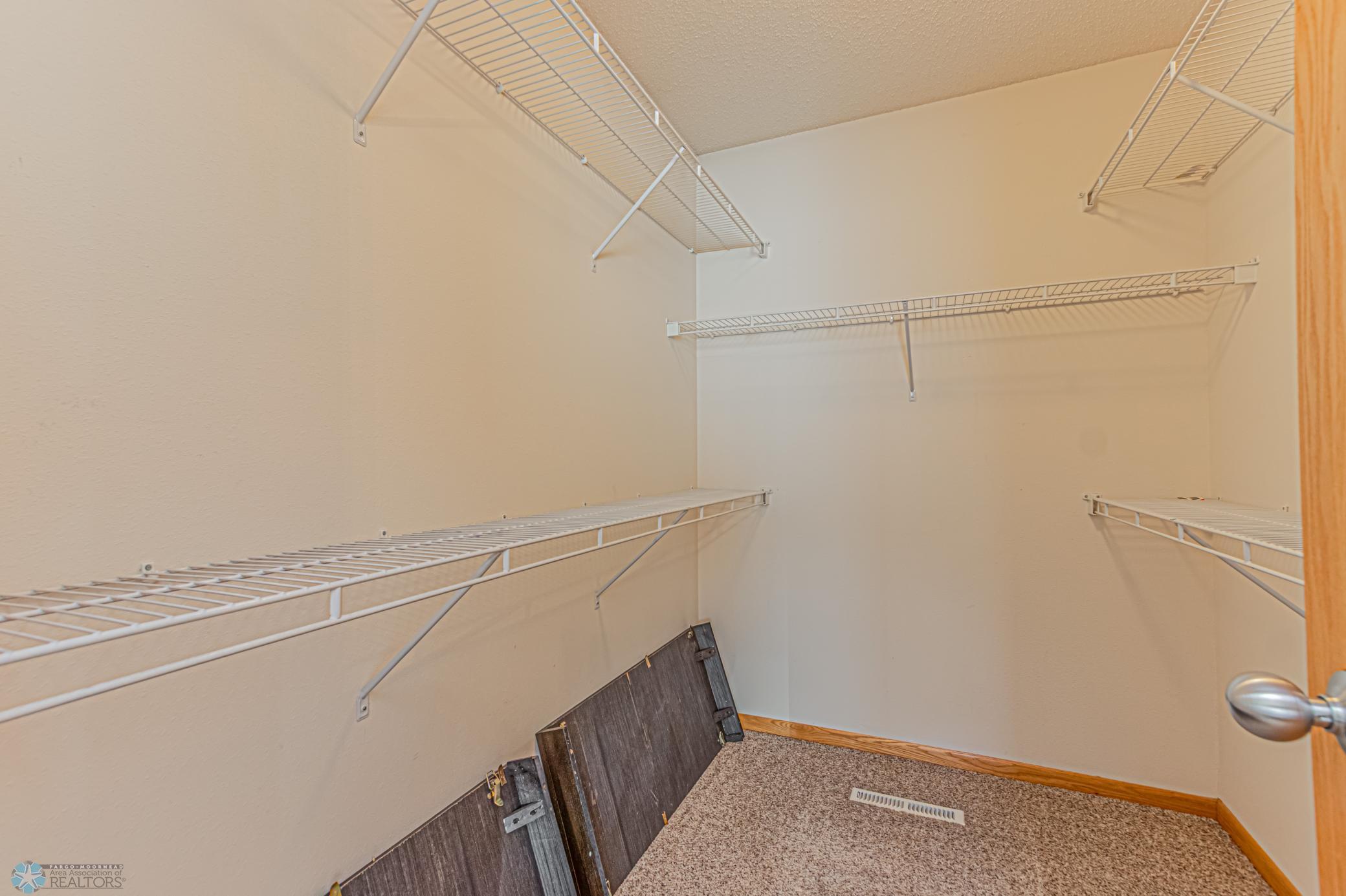 Primary bedroom walk in closet