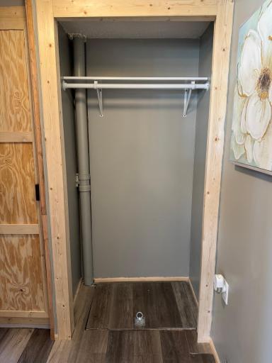 A shot of the supply closet with a crawl space access door. Block foundation in crawl space and boiler system that previously served the cabin is in crawl space and needs to be replaced.