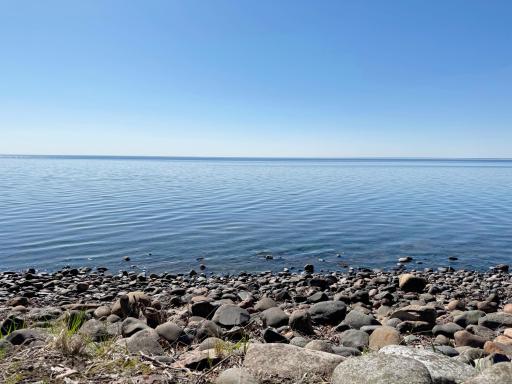 Shoreline and panoramic lake view...just a few feet of rocks lead to the SAND beach just beyond!