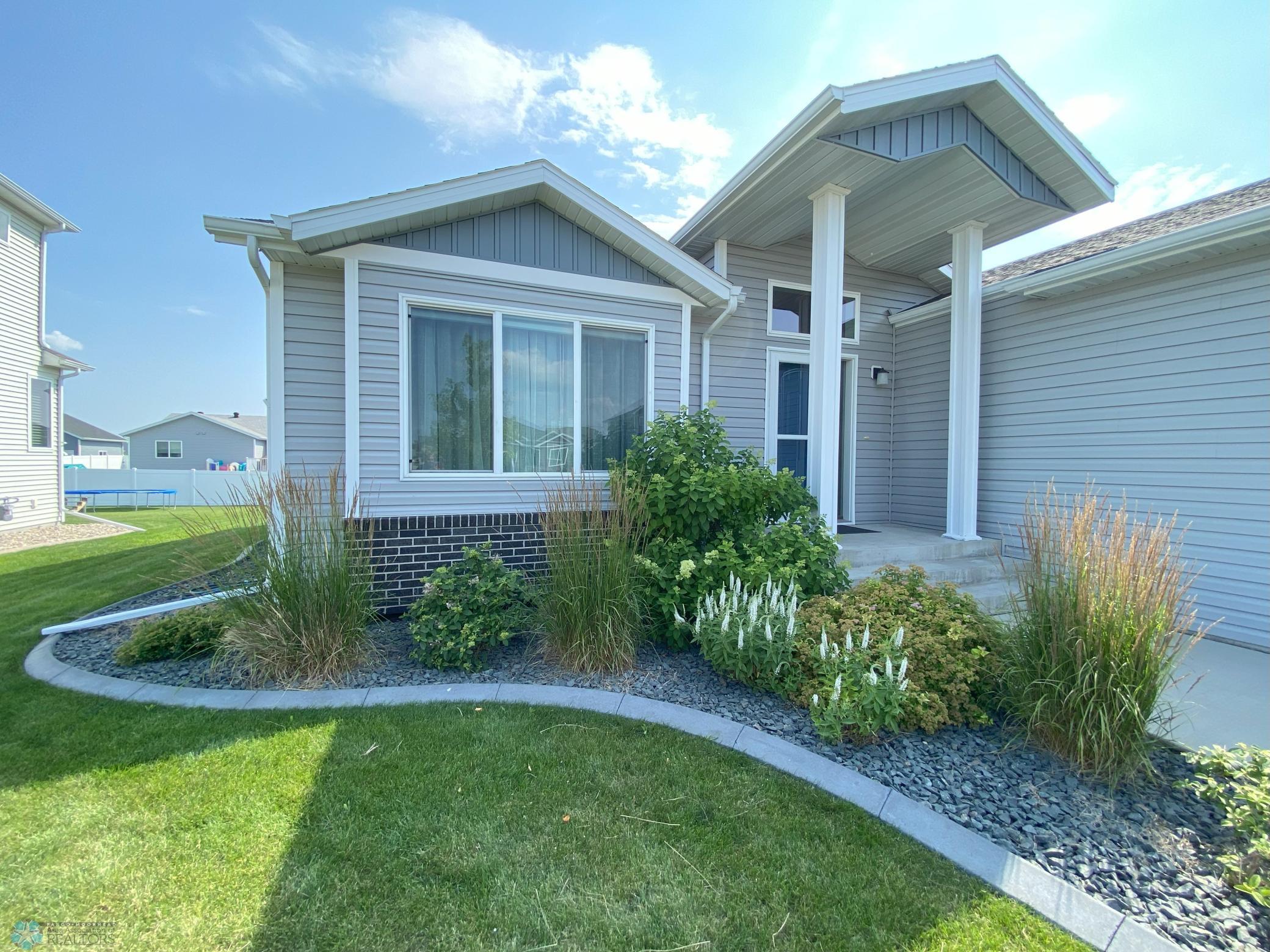 front of house with blooming landscaping .jpeg