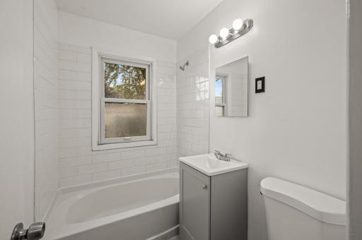 Full bath on main level, ceramic tub surrond
