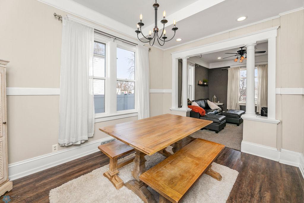 Dining Room features high ceilings, crown molding, chair rail, chandelier, & tray ceiling.