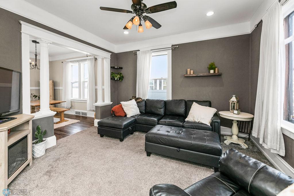 Living Room features high ceilings, recessed lighting, ceilings fan & columns