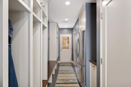 Lockers, closet, full sized refrigerator and pool bath in mud room. Door provides access to hot tub and pool