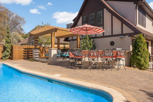 Outdoor entertainment area by Southview Design includes dining pavilion