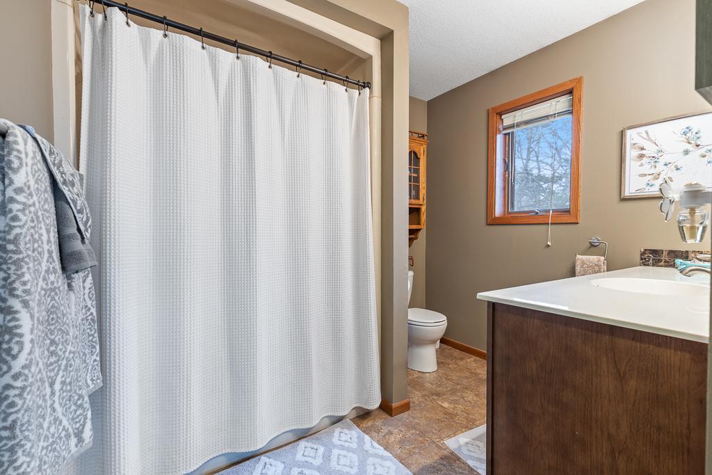 The main floor full bathroom! Fully accessible via the primary bedroom and near the kitchen/sitting area