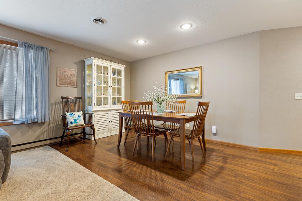 A change in flooring separates the open room, creating a distinct dining space.