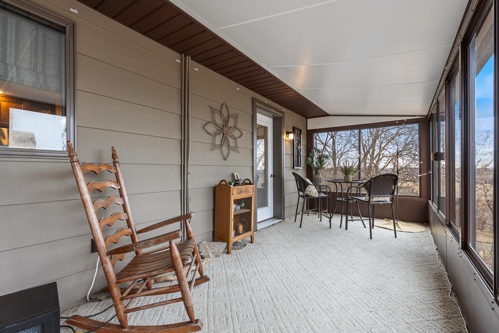 The second porch entry brings you right in to a secondary sitting area with the same view to the north overlooking the golf course