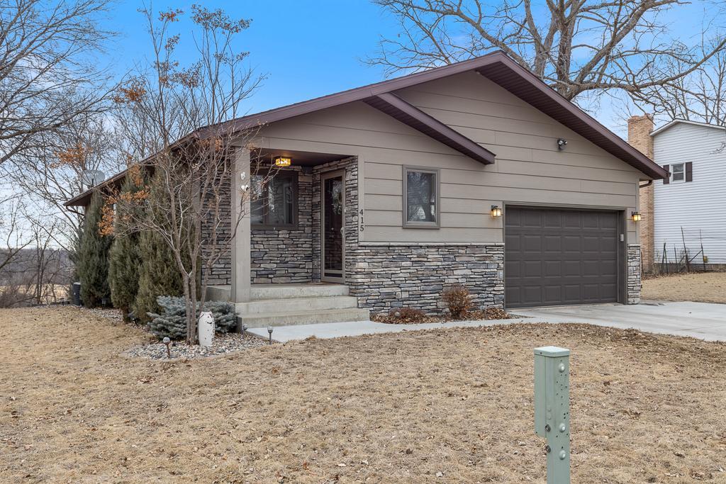 Stunning stone work, engineered wood siding, a new driveway, stunning landscaping, and MORE!