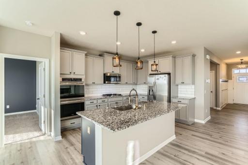 Open kitchen with granite, backsplash, new faucet and light fixtures