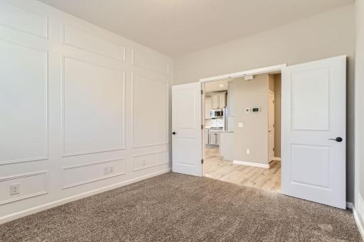 Office/flex room with hand crafted wall detailing and French doors