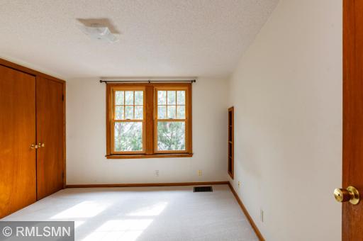 Upper level south bedroom has built-in bookcase.