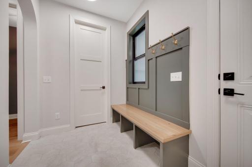 Your generous Mud Room boasts a walk-in closet, bench, hooks and PEEK the window into the SPORT COURT.