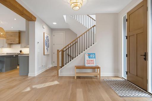Gracious entry with additional coat closet near stairwell.