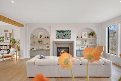 Framed with custom-built ins, floating shelves, arch detailing, oversized windows, in-ceiling audio.