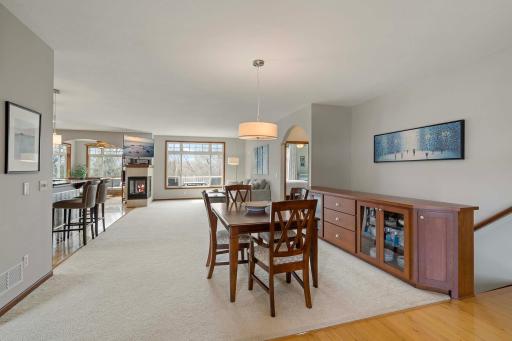 The open-concept dining, living, kitchen and sunroom is lit with natural light in this end-unit.