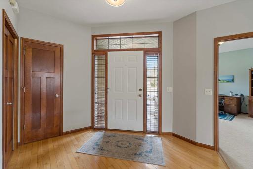 Enter the front door and you'll be welcomed by hardwood floors - the home office is just to the right of the front door. A half bath is at the left of the photo.