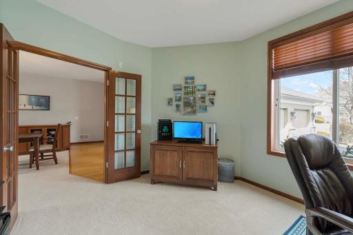 Glassed French doors lead to the home office.