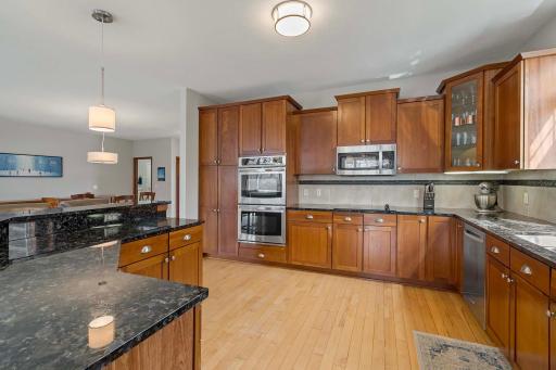 The kitchen shines with cherry cabinetry, granite countertops, stainless steel appliances and hardwood floors.
