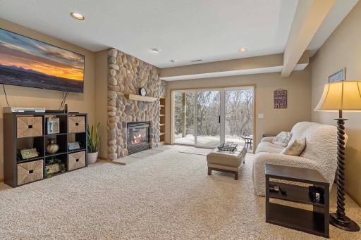 Lower level walkout to a patio that overlooks a wooded area behind the property.