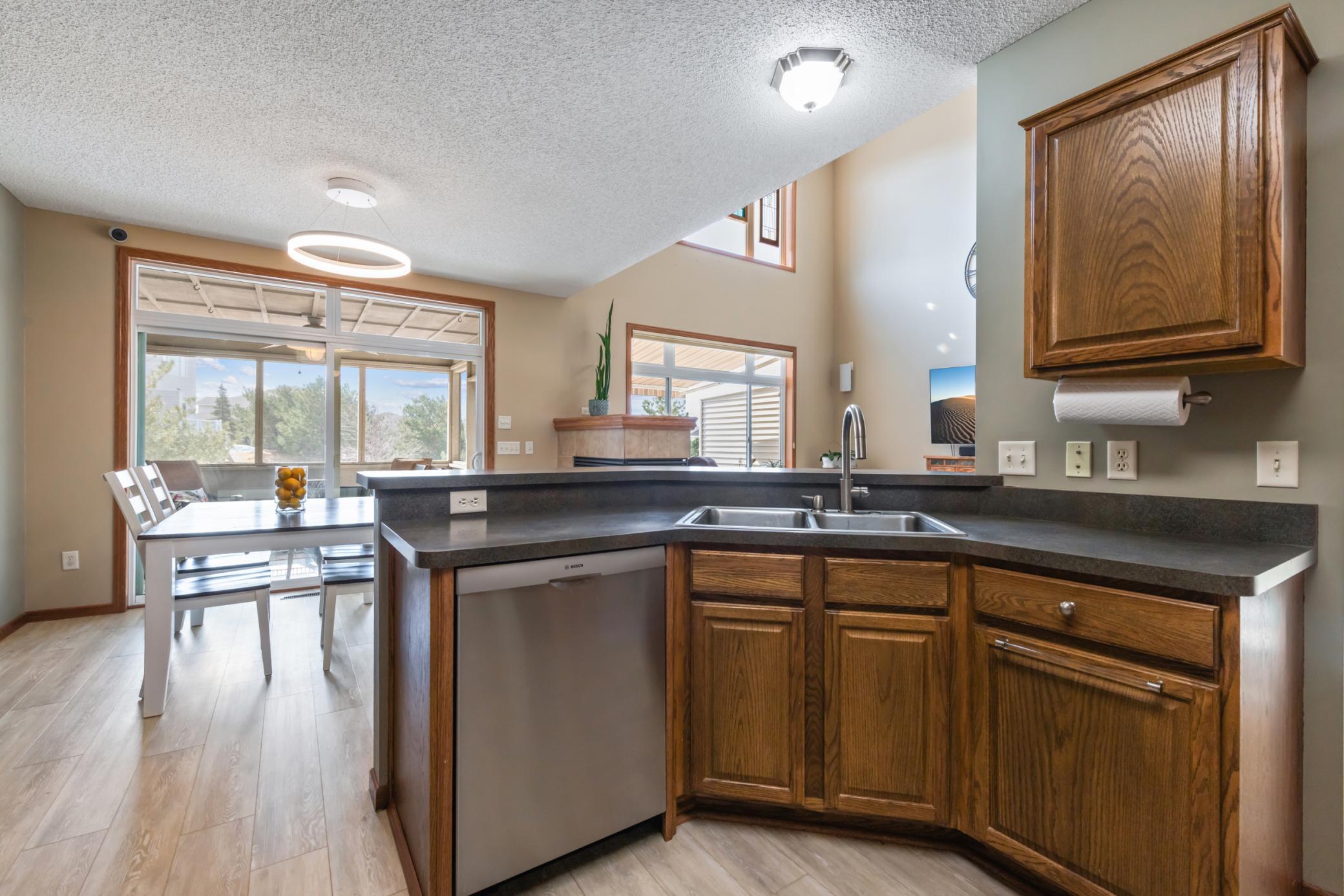 No one is stuck in the kitchen in this open floor plan and breakfast bar.