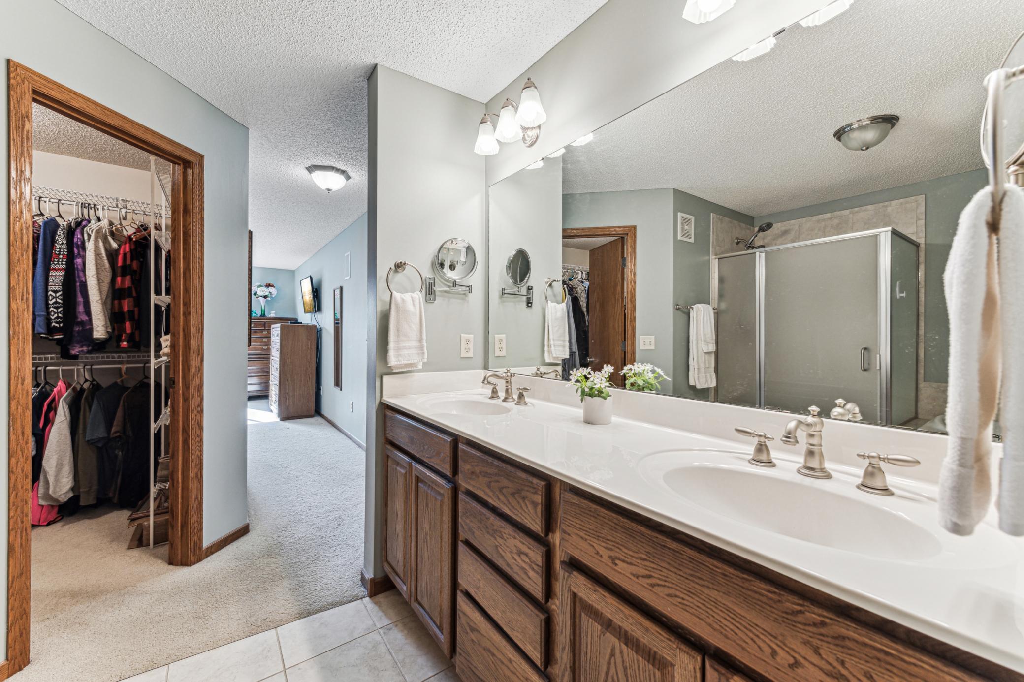 Private full bath offers dual sinks, large walk-in closet, separate tub and shower.