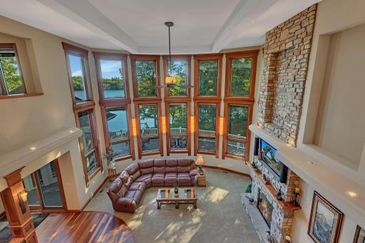 From the moment you enter, you'll be captivated by the breathtaking wall of windows that flood the home with natural light and frame serene lake views.
