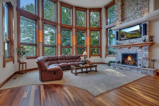 A beautiful floor-to-ceiling gas fireplace adds warmth to this impressive space.