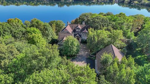 This estate also offers a heated three-car attached garage, an additional heated three-car garage on the lower level, and a separate 48 x 50 outbuilding for added storage.