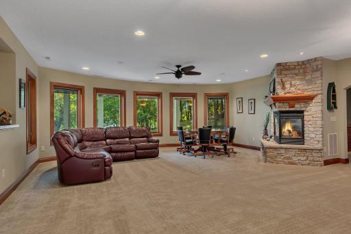 Designed for ultimate entertainment, the lower-level walkout features a lakeside family room with a gas fireplace, a state-of-the-art home theater, a wet bar, a flex room, and a sauna.