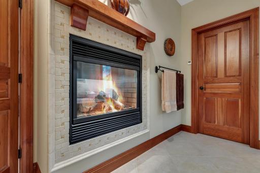The owners ensuite is a true sanctuary, featuring a stunning see-through fireplace that creates a warm and relaxing atmosphere.