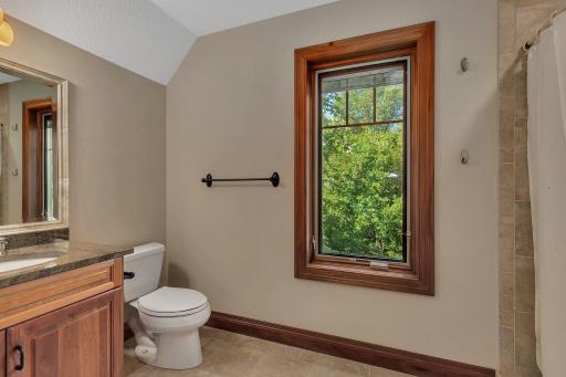 This private three-quarter bathroom is located within the bonus bunk area. The bathroom includes a tiled shower, perfect for convenience and privacy for guests staying in the bunk room.