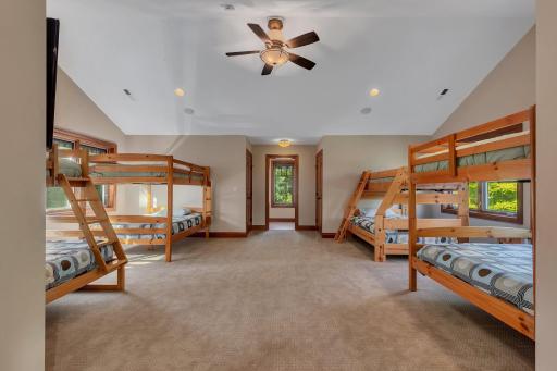 The rooms high ceilings and large windows enhance the sense of space, while neutral tones and plush carpeting create a cozy, comfortable atmosphere.